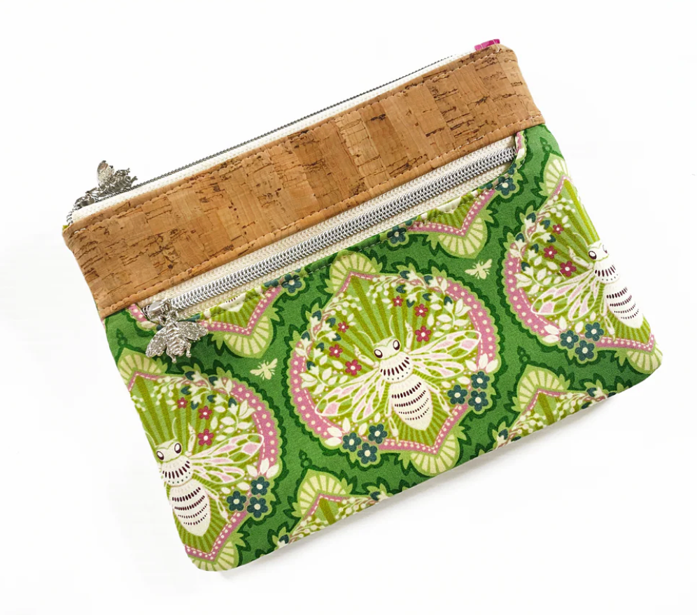 Green patterned pouch with cork top and zipper on a white background